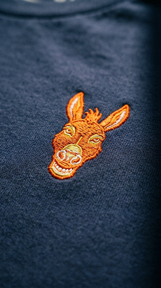 STBN Born Difficult navy embroidered graphic tee flat lay showing chest logo 