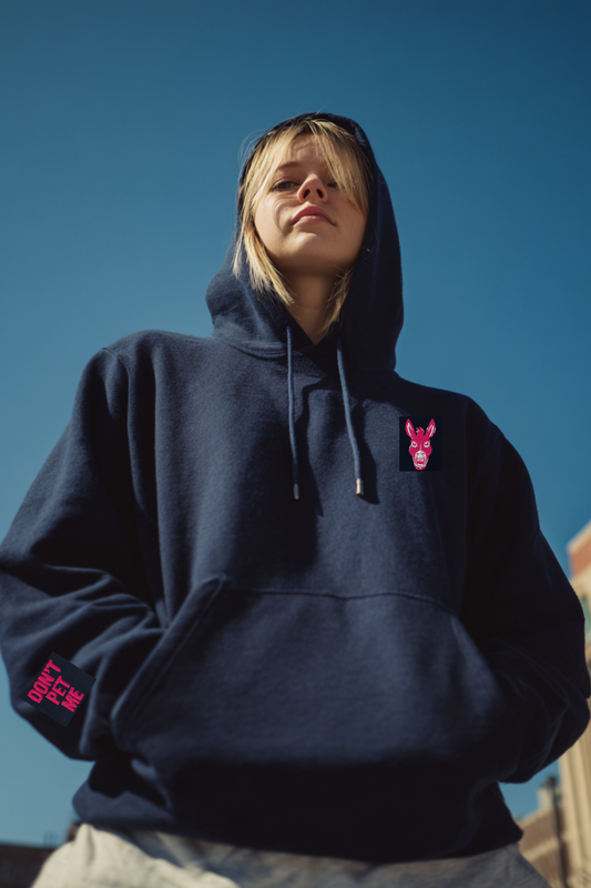 Person wearing a navy blue hoodie with pink logo against a clear blue sky